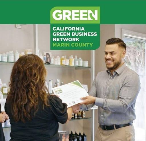 a business owner receiving their Green Business Certificate with the CA Green Business Logo above